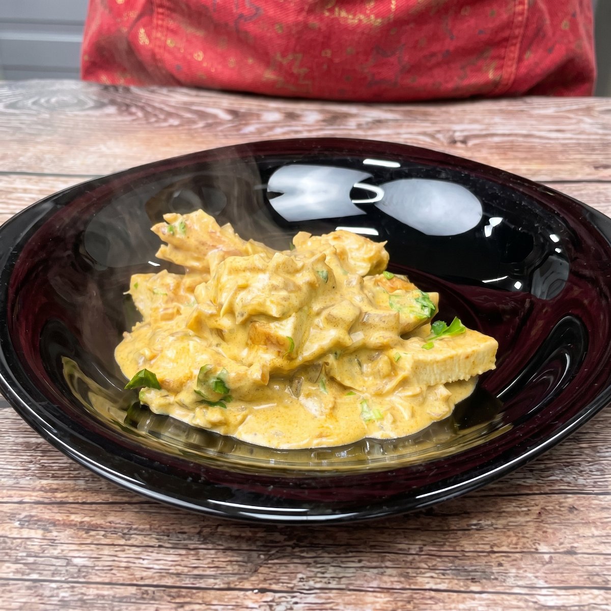 Chicken coated in creamy mustard sauce on a plate.