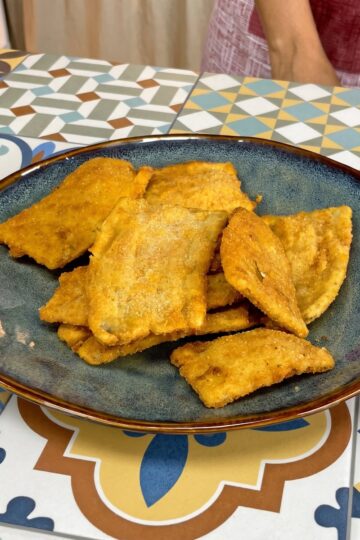 Golden and crispy fried banana peel snack served on a plate.