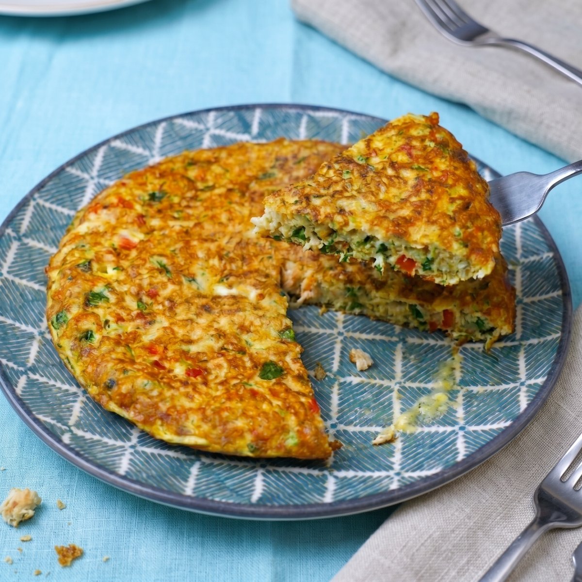 Tuna and mozzarella omelet with one slice being served with a fork.